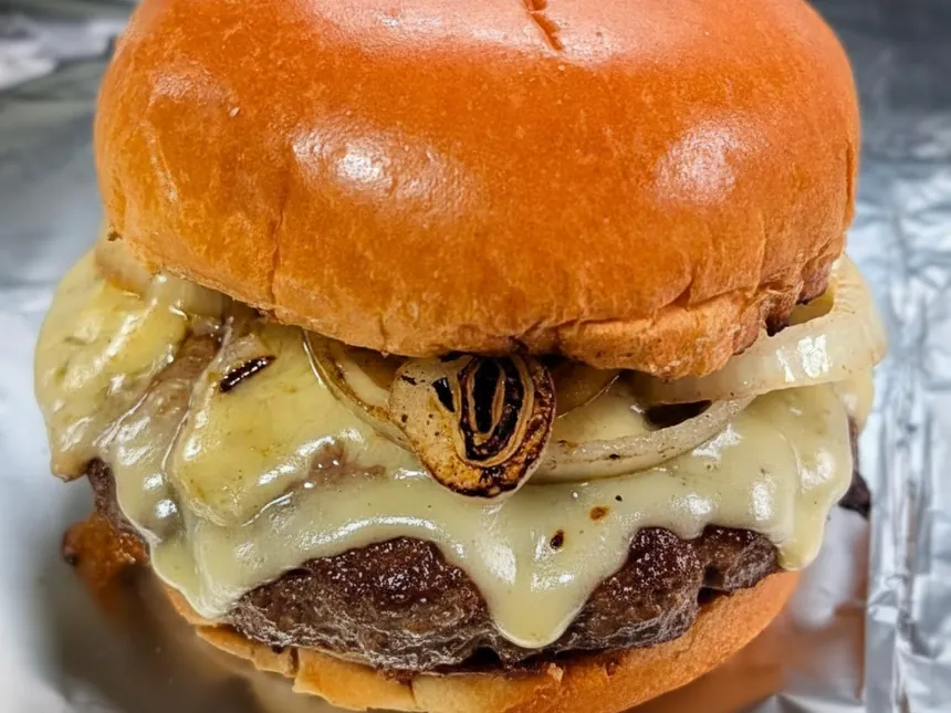 Barney's cheeseburger, griddled beef patty, melted cheese and caramelised onions on a brioche bun